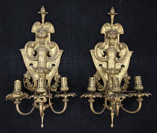 A pair of early 20th century ornate gilt bronze three branch wall lights, 1ft 10in.